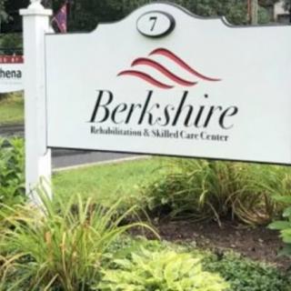 Sign for Berkshire Rehabilitation & Skilled Care Center surrounded by greenery.