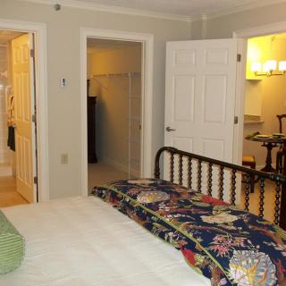 Cozy bedroom with a bed, closet, and adjacent bathroom.