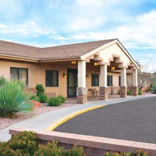 A welcoming residential building surrounded by desert landscaping.