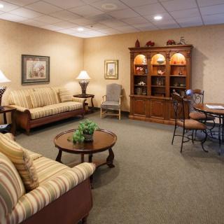 A cozy living room with comfortable sofas, a coffee table, and a cabinet.