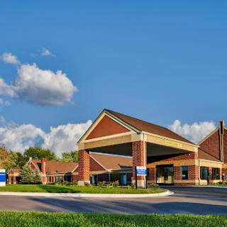 A welcoming facade of a hospitality establishment under a bright blue sky.