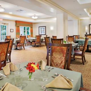 A well-appointed dining room with elegantly set tables and comfortable chairs.