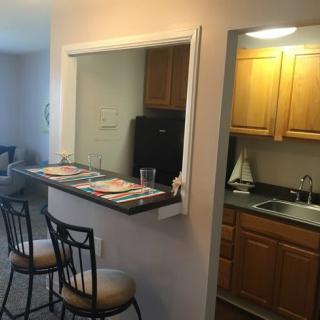 Cozy apartment kitchen with a dining area and countertop seating.