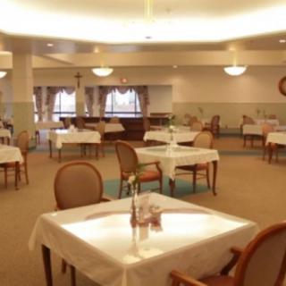 An empty dining room with elegantly set tables and comfortable seating.