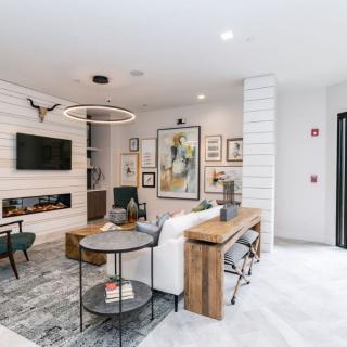 A stylish and modern living room featuring contemporary furniture, wall art, and sleek decor.