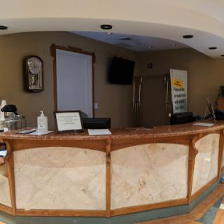 A view of a hotel reception area with a stylish counter.