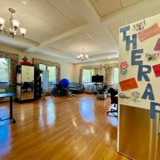 A bright and spacious therapy room featuring colorful signage and a welcoming atmosphere.