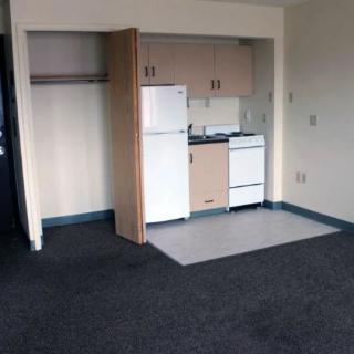 A compact kitchenette in a small apartment space.