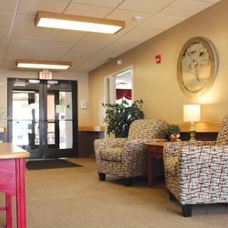 A cozy waiting area featuring comfortable chairs and a warm atmosphere.