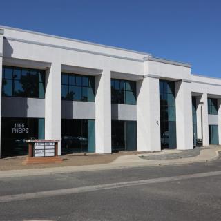 A modern commercial office building with large windows and a sleek design.