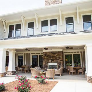 A beautiful home exterior with a spacious patio and comfortable seating area.