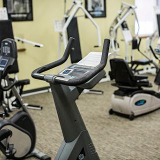 A view of a gym featuring various exercise machines, including a stationary bike.