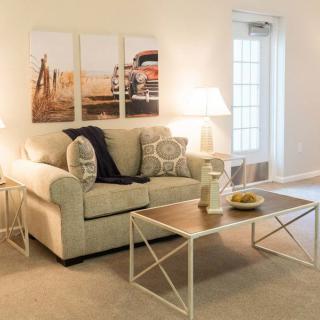 A cozy living room featuring a comfortable sofa, modern coffee table, and warm lighting.