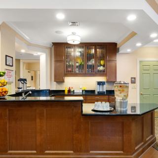 A modern kitchen with wooden cabinets and a granite countertop.