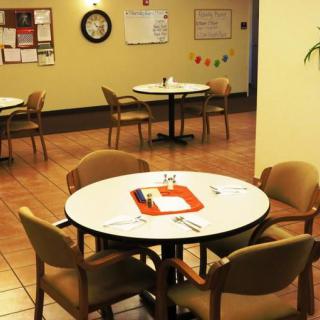 An indoor dining area with tables and chairs arranged neatly.