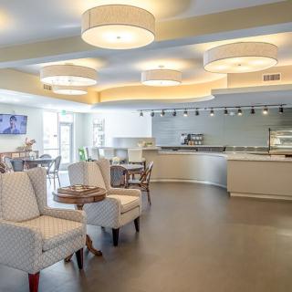 A modern cafe interior with comfortable seating and sleek lighting.