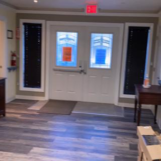 A well-lit entrance area with double doors and a visible exit sign.