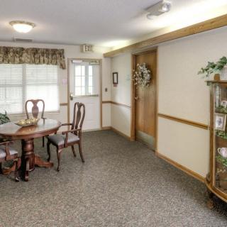 A cozy dining area with wooden furniture and decorative elements.