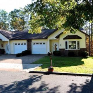 A suburban house with a double garage and a well-maintained lawn.