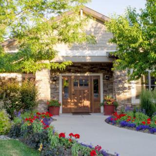 A charming house entrance with a vibrant garden.