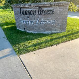 Entrance sign for Canyon Breeze Senior Living facility.