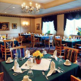 A well-decorated restaurant dining room with tables set for guests.