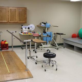 A well-equipped physical therapy room featuring various rehabilitation tools and equipment.