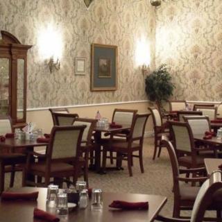 An elegantly decorated dining area with neatly arranged tables and chairs.