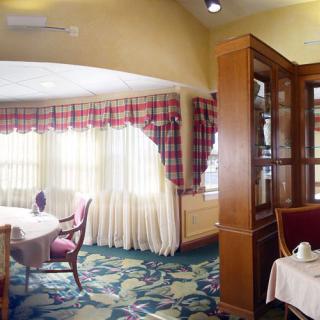 A cozy restaurant dining area with elegant furnishings and large windows.