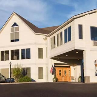 A modern building with large windows and a wooden entrance.