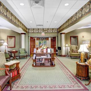 A cozy waiting room with comfortable seating, a decorative rug, and ambient lighting.