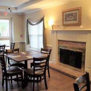 A cozy dining room with a fireplace and wooden furniture.