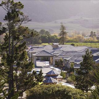A large house surrounded by trees and natural landscape.
