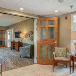 A cozy living area with chairs, a wooden door, and decorative elements.