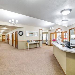 A spacious office reception area with a hallway and welcoming decor.