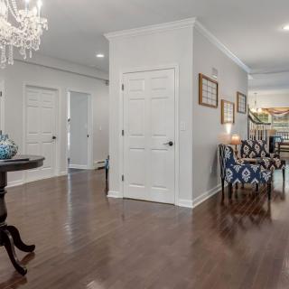 A well-decorated interior hallway featuring elegant furniture and a chandelier.