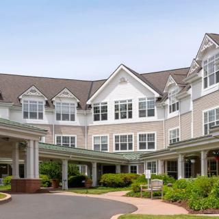 A residential building with a landscaped entrance.
