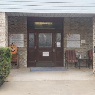 Entrance view of a building showcasing the main door and seating area.