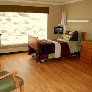 A well-designed hospital patient room featuring a comfortable bed, modern amenities, and natural lighting.