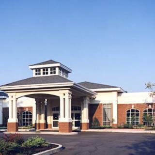 A healthcare facility with a prominent entrance and architectural design.