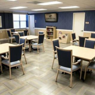 An empty dining area with several tables and chairs arranged neatly.