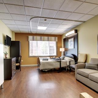 A well-furnished hospital room designed for patient comfort.
