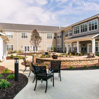 A well-maintained courtyard with seating and landscaping outside a residential building.
