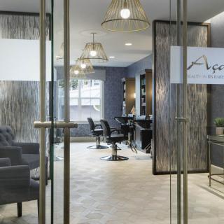 A modern hair salon interior with stylish decor and comfortable seating.