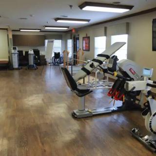 A spacious gym with various exercise equipment and cardio machines.
