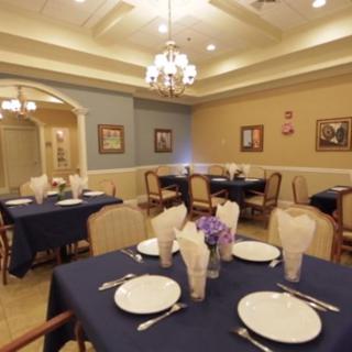 An elegant dining room with neatly set tables and soft lighting.