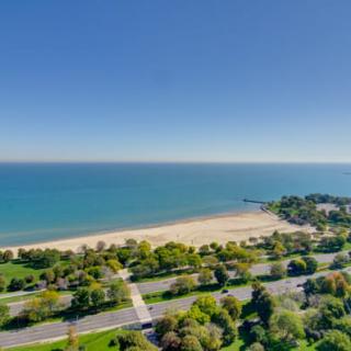 A scenic view of a beach with clear blue skies and tranquil waters.