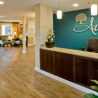 A modern reception area with a wooden desk and stylish decor.
