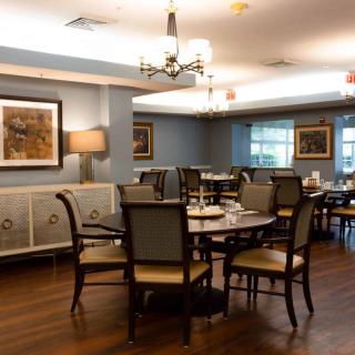A cozy dining room with elegant furnishings and warm lighting.