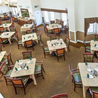 An empty restaurant dining area with neatly arranged tables and chairs.